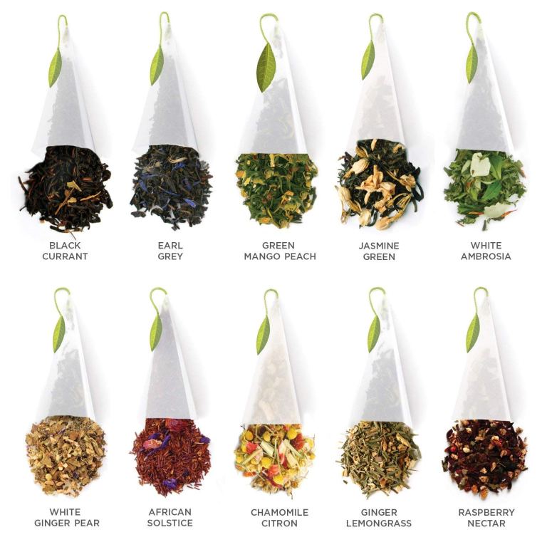 A variety of tea bags arranged in two rows, showcasing different flavors such as Black Currant, Earl Grey, Green Mango Peach, Jasmine Green, White Ambrosia, White Ginger Pear, African Solstice, Chamomile Citron, Ginger Lemongrass, and Raspberry Nectar.