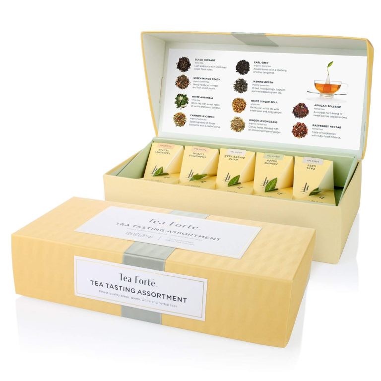 An open tea assortment box from Tea Forte, showcasing various teas inside with a guide to the flavors included.