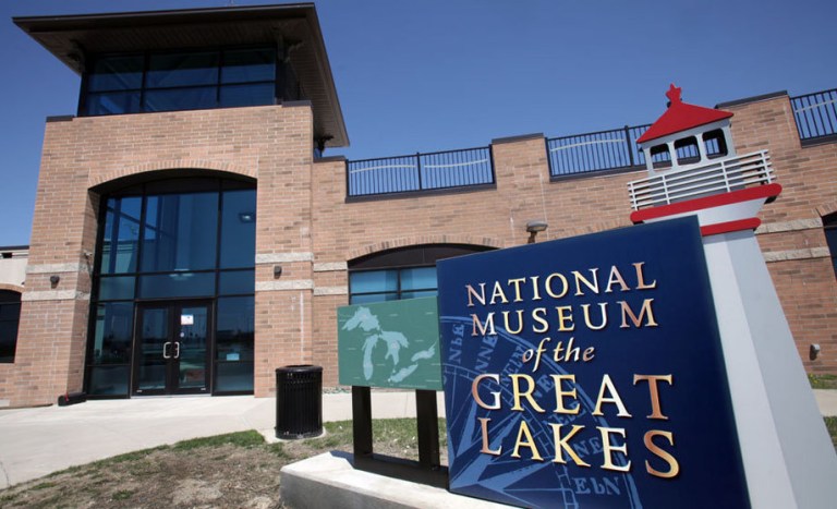 Exterior view of the National Museum of the Great Lakes, featuring a brick building and a prominent sign with the museum's name.