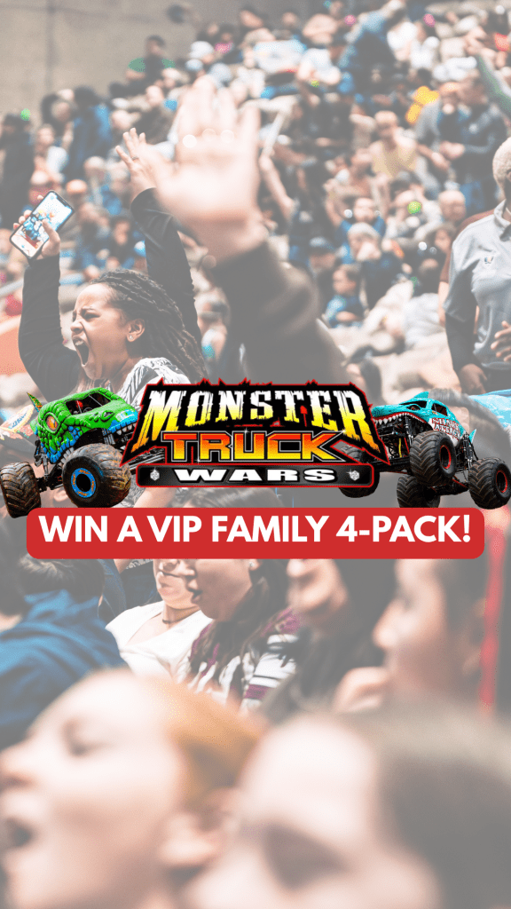 Audience cheering at a Monster Truck Wars event with a promotional banner for a VIP family 4-pack.